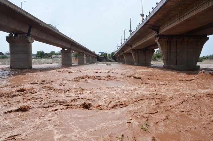 Water overflows the banks of the Tawi River in Jammu on Wednesday, June 22, 2022
